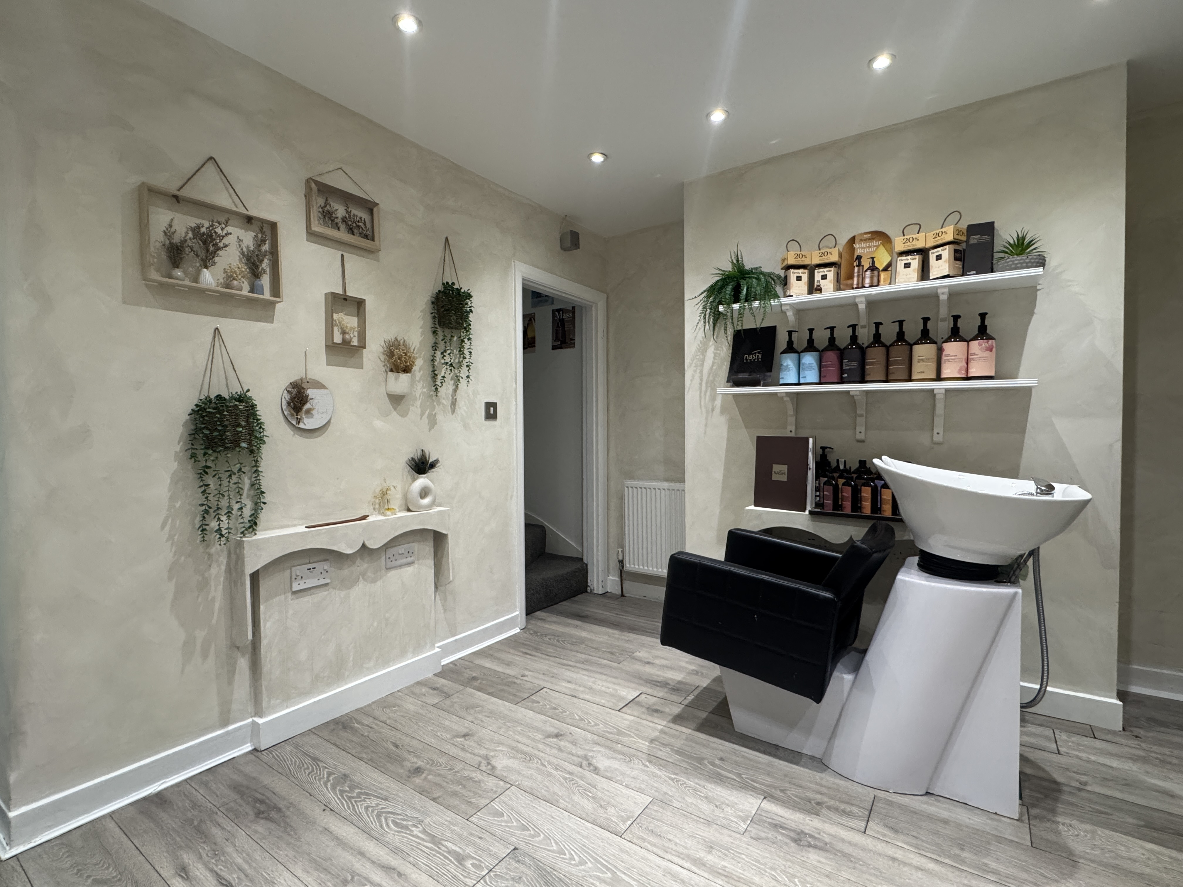 Salon wall decor with plants and styling stations